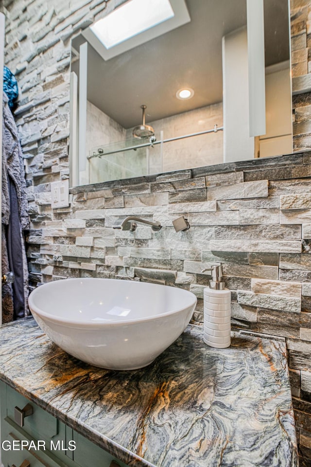 bathroom with a skylight and sink