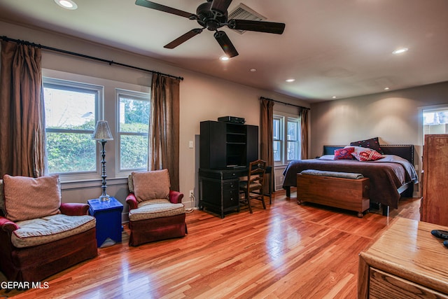 bedroom featuring multiple windows, ceiling fan, and light hardwood / wood-style floors