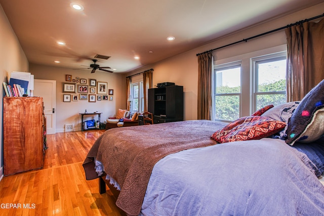 bedroom with light hardwood / wood-style floors and ceiling fan