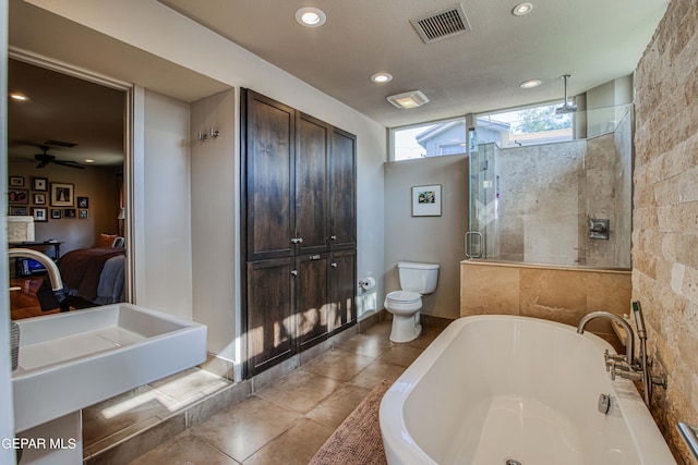 full bathroom featuring toilet, independent shower and bath, and sink