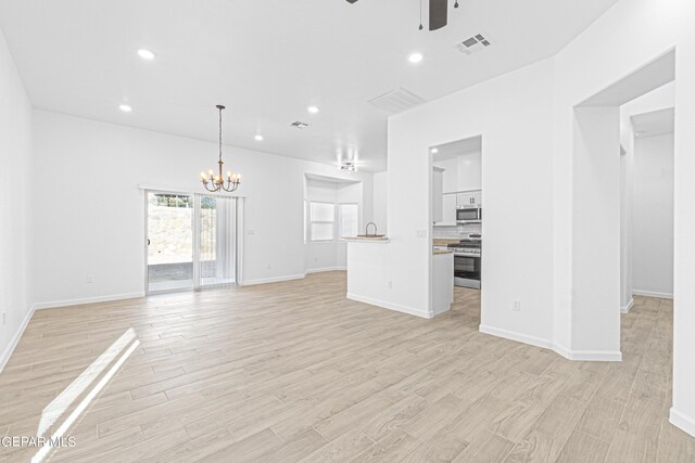 471 Huereque Dr # A, Socorro, TX 79927 - unfurnished living room featuring ceiling fan with notable chandelier and light hardwood / wood-style flooring