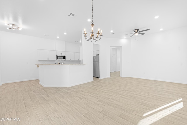 471 Huereque Dr # A, Socorro, TX 79927 - kitchen with white cabinetry, decorative backsplash, light hardwood / wood-style flooring, and stainless steel appliances