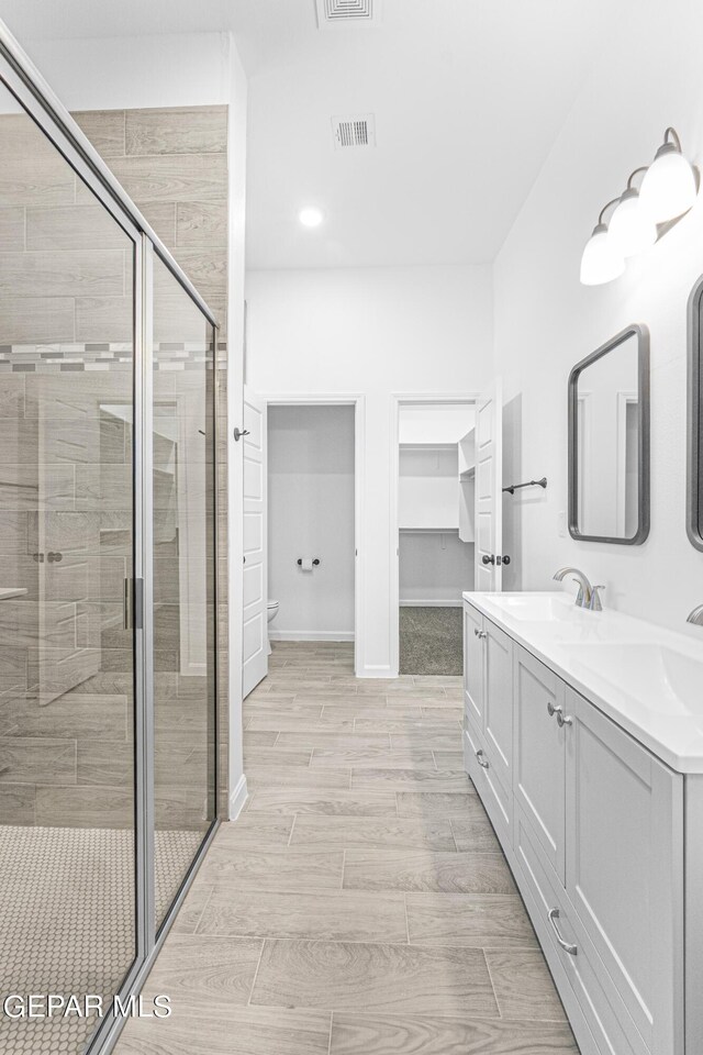 471 Huereque Dr # A, Socorro, TX 79927 - bathroom with an enclosed shower, vanity, and toilet