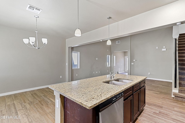 kitchen with sink, hanging light fixtures, dark brown cabinets, an island with sink, and stainless steel dishwasher