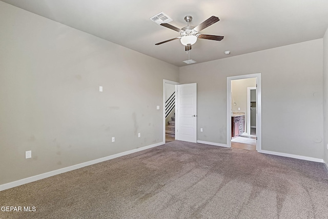 unfurnished bedroom featuring ceiling fan, carpet, and ensuite bath