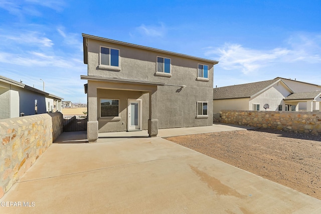 back of property with a patio