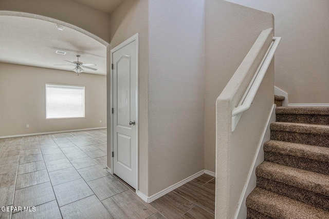 stairway with ceiling fan