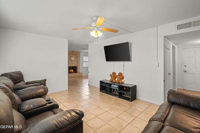 tiled living room with a brick fireplace and ceiling fan