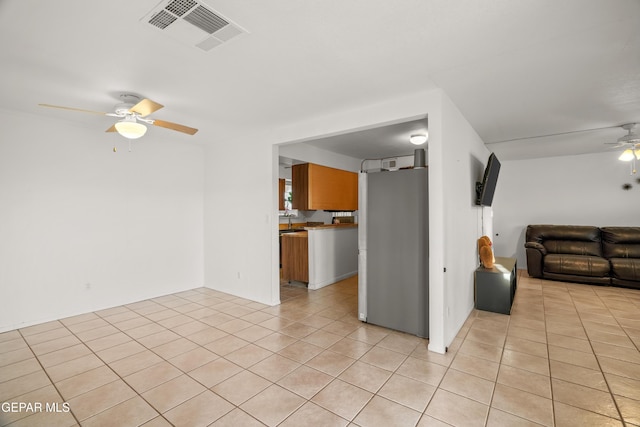 unfurnished living room with ceiling fan and light tile patterned flooring