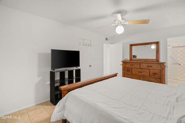 tiled bedroom with ensuite bath and ceiling fan