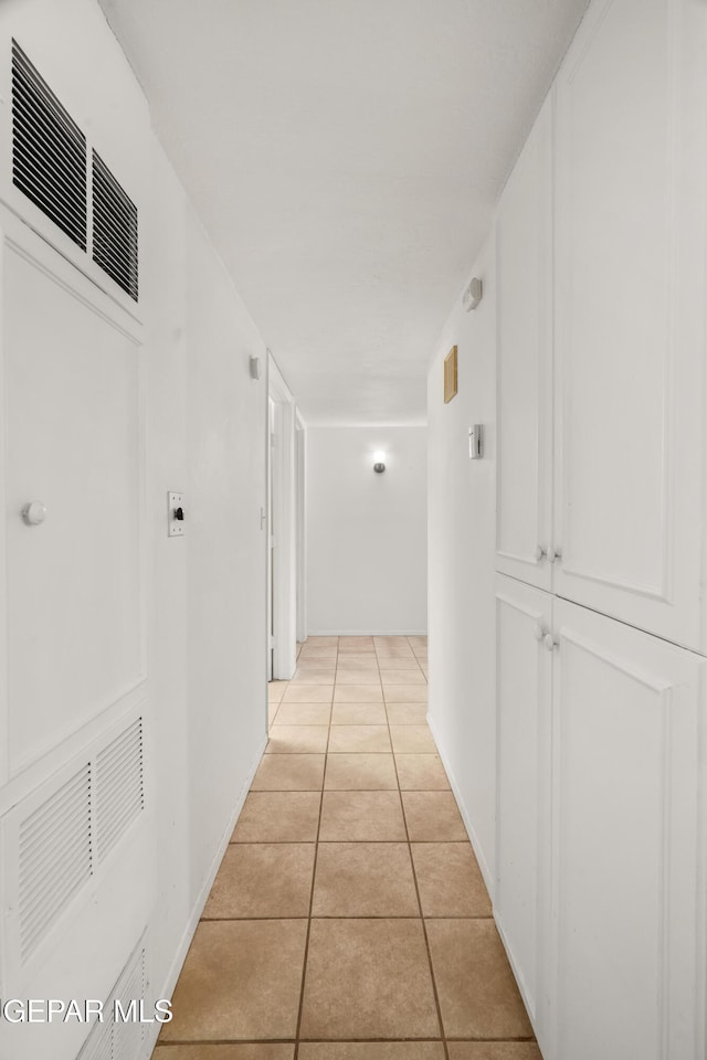 hall with light tile patterned floors