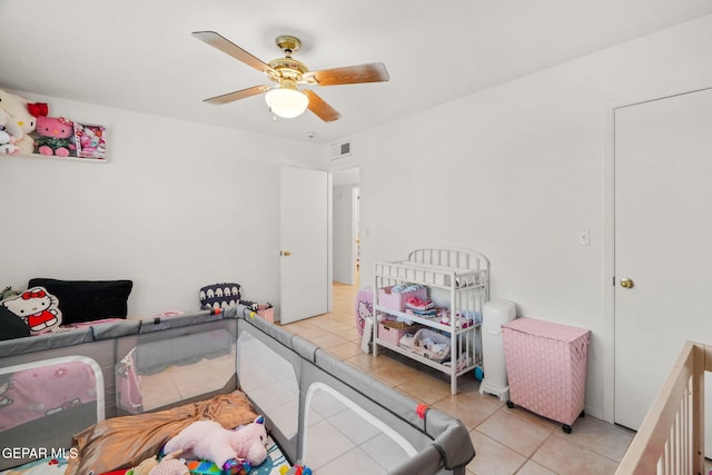 tiled bedroom featuring ceiling fan