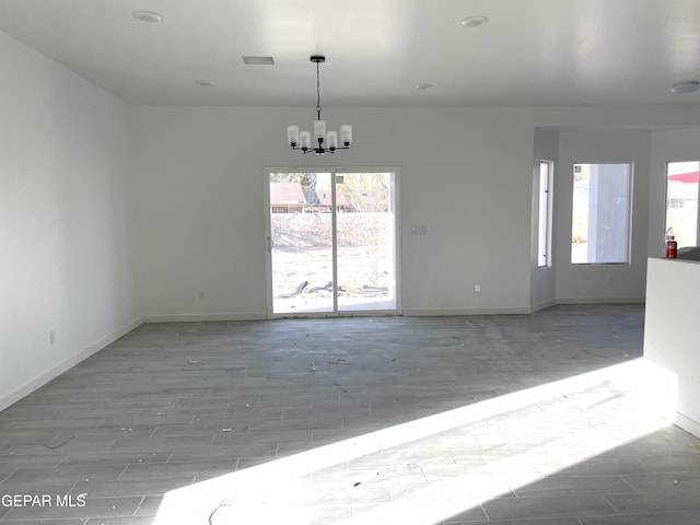 empty room featuring an inviting chandelier