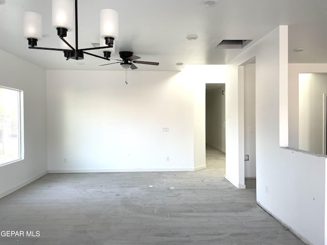 empty room with ceiling fan and light hardwood / wood-style floors