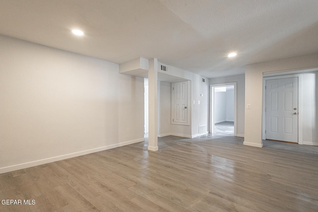 interior space featuring light wood-style floors, visible vents, baseboards, and recessed lighting