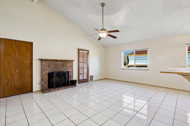 unfurnished living room with ceiling fan, a fireplace, high vaulted ceiling, and light tile patterned floors