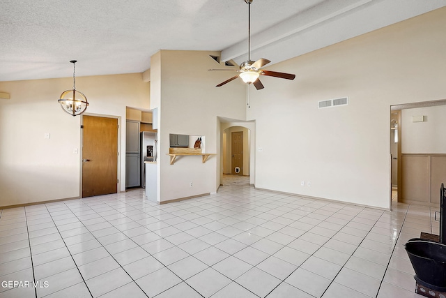 unfurnished living room with light tile patterned floors, high vaulted ceiling, a textured ceiling, ceiling fan with notable chandelier, and beamed ceiling