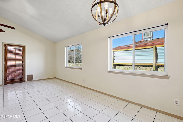 unfurnished room with ceiling fan with notable chandelier, vaulted ceiling, and light tile patterned floors