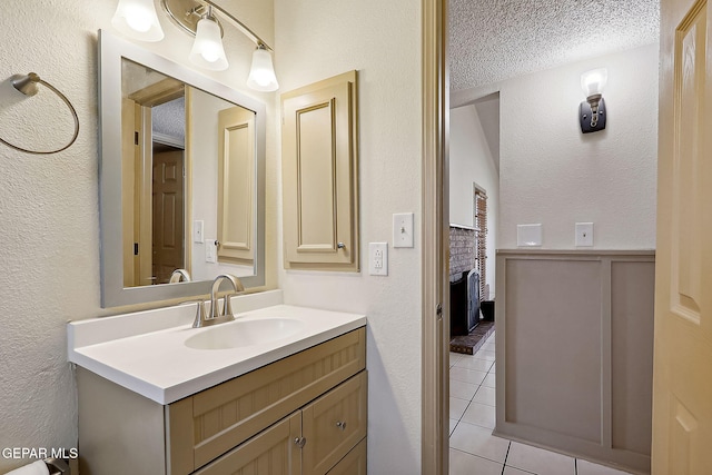 bathroom featuring vanity, tile patterned floors, and a textured ceiling