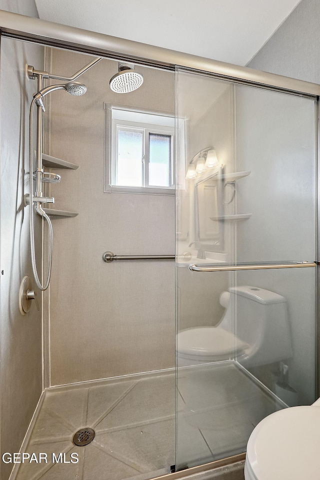 bathroom with toilet and walk in shower