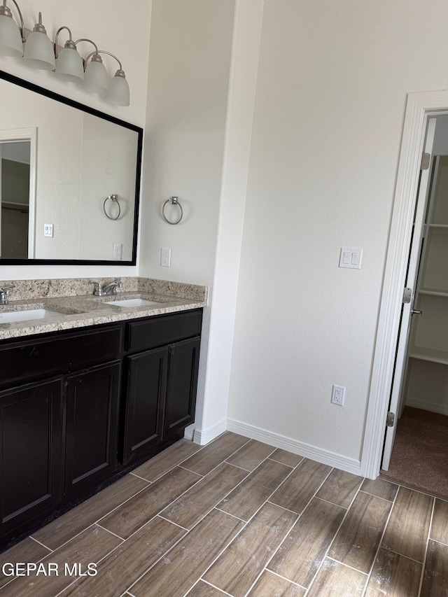 bathroom featuring a sink and wood finish floors