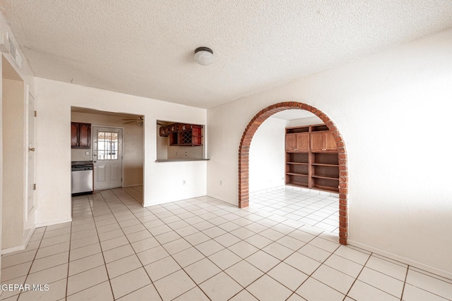 empty room featuring light tile patterned floors and a textured ceiling