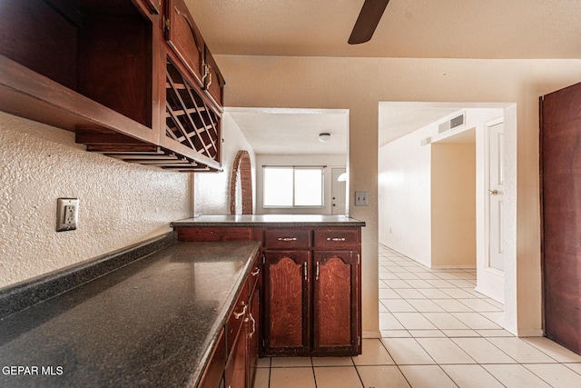 kitchen with dark brown cabinets and light tile patterned floors