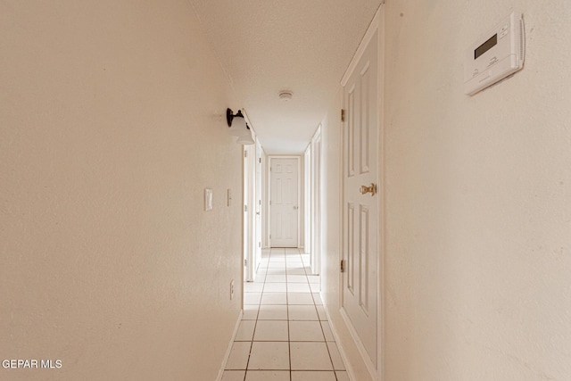 corridor featuring light tile patterned floors