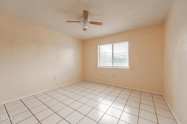 spare room featuring ceiling fan, a textured ceiling, and light tile patterned floors