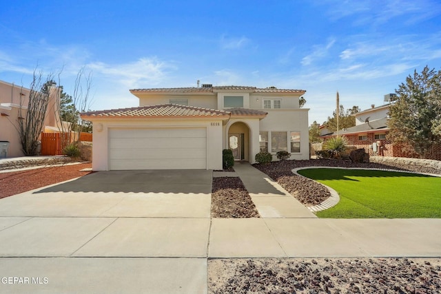 mediterranean / spanish-style home with a garage and a front lawn