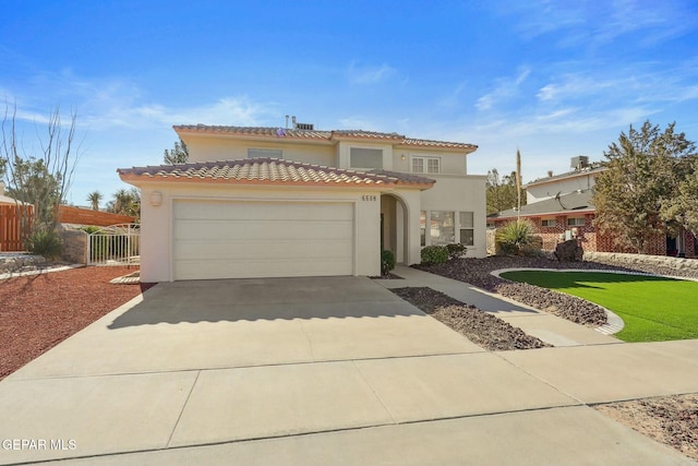 mediterranean / spanish house with a garage