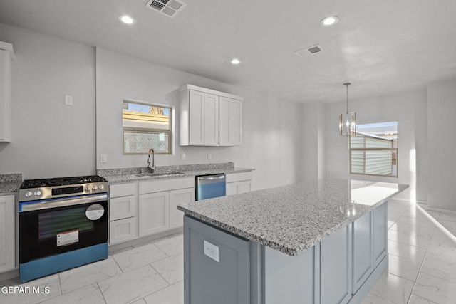 kitchen featuring sink, white cabinetry, decorative light fixtures, a kitchen island, and stainless steel appliances