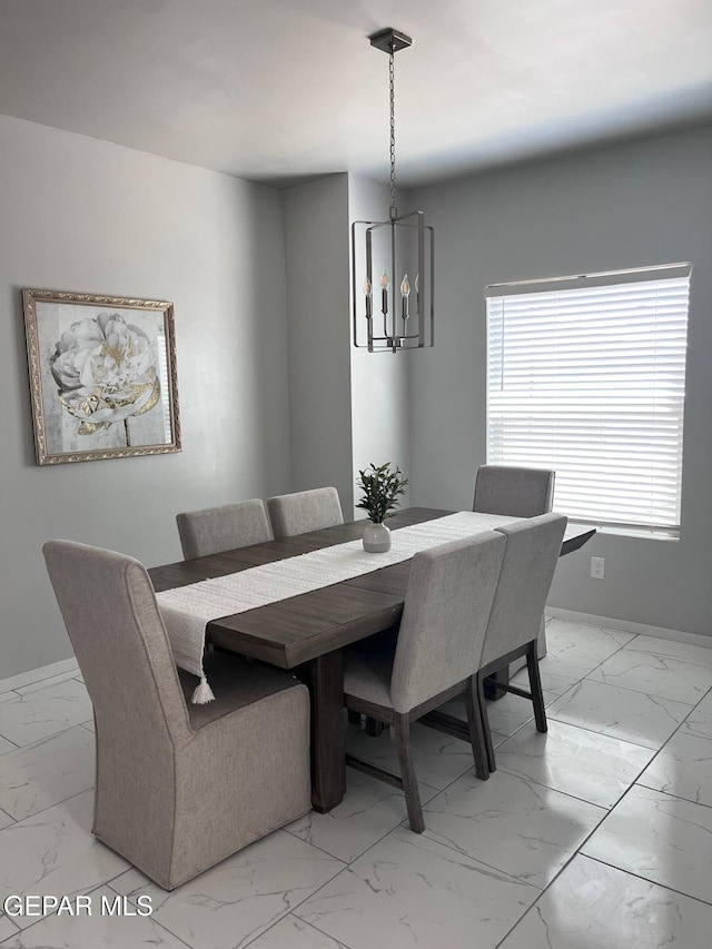 dining area featuring a notable chandelier