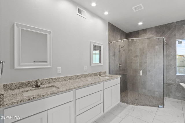 bathroom featuring vanity and a shower with shower door