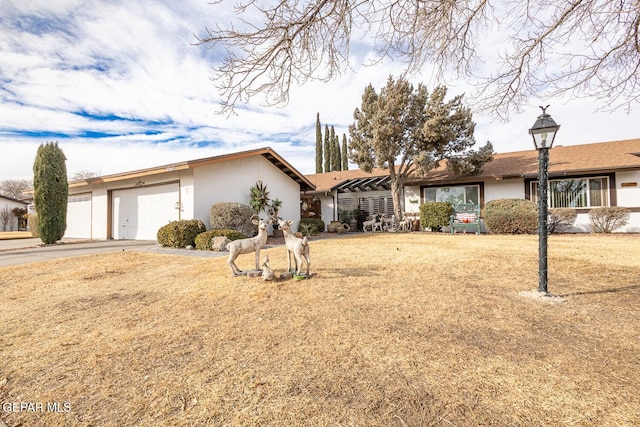 ranch-style house with a garage and a front yard