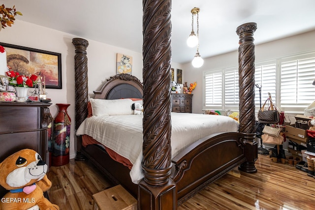 bedroom with dark hardwood / wood-style floors