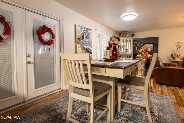 dining space with hardwood / wood-style flooring