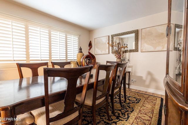 dining space with wood-type flooring