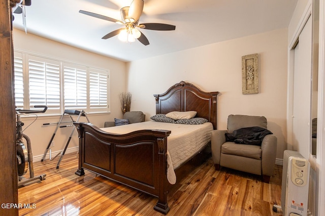 bedroom with light hardwood / wood-style flooring, a closet, and ceiling fan