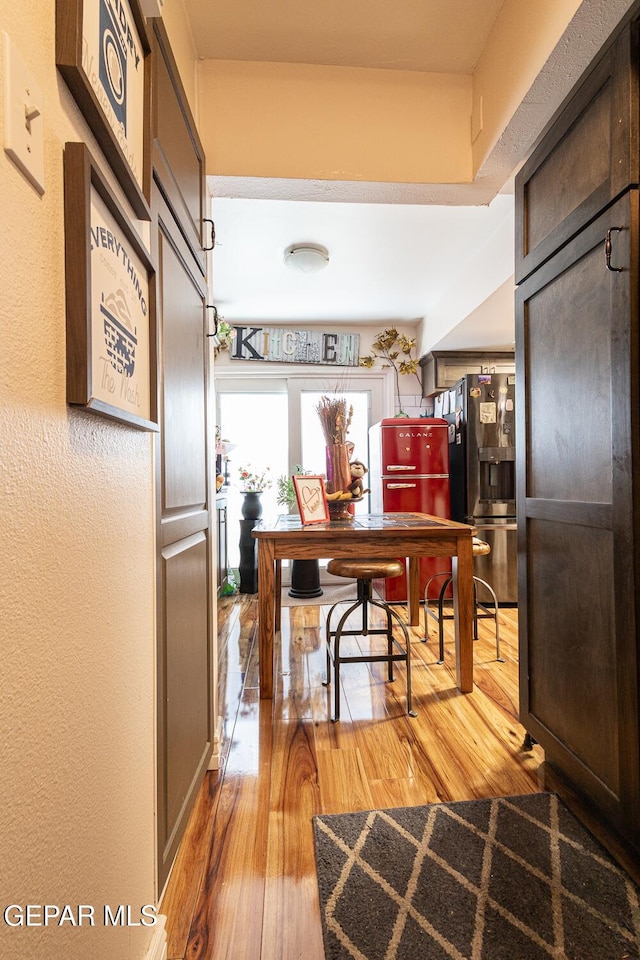 corridor with light hardwood / wood-style floors