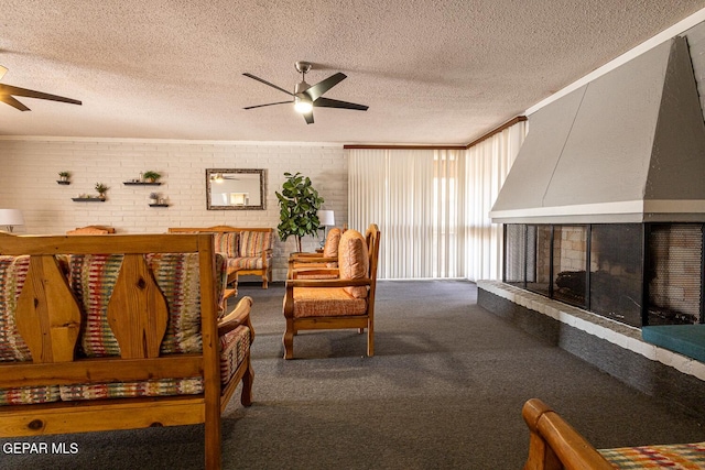 living room with crown molding, a textured ceiling, a multi sided fireplace, carpet flooring, and ceiling fan