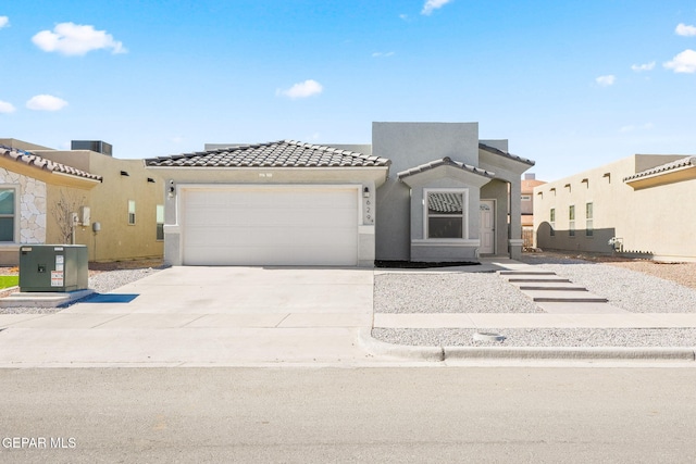 view of front of house featuring a garage and central air condition unit