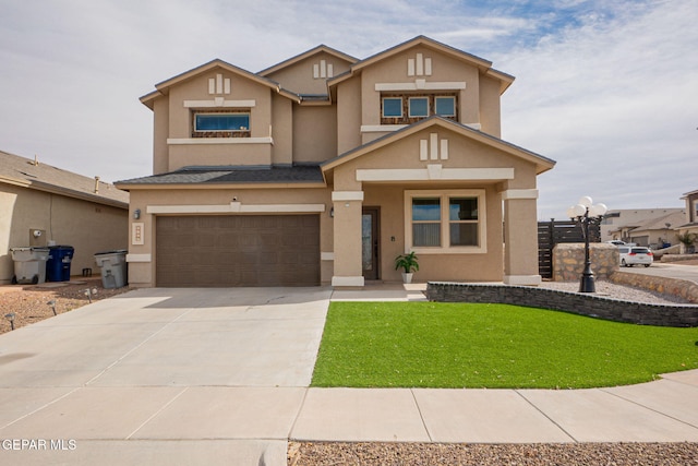 view of front of property featuring a garage and a front yard