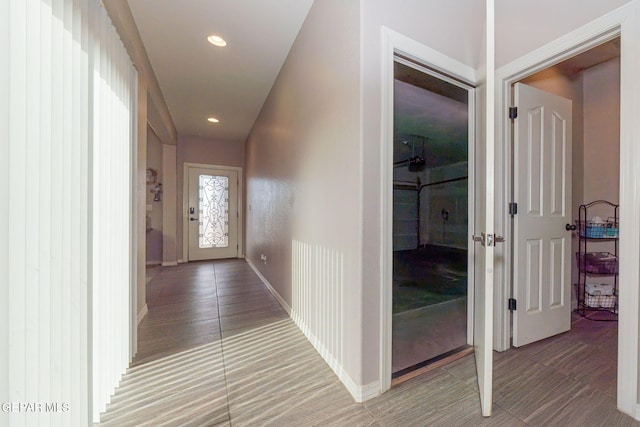 hallway with hardwood / wood-style floors