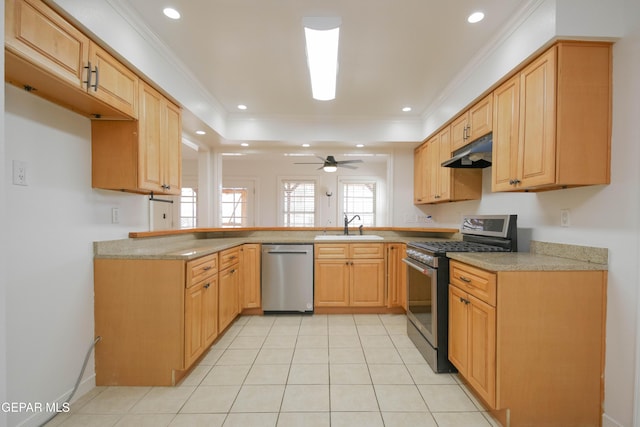 kitchen with light tile patterned flooring, ornamental molding, appliances with stainless steel finishes, and sink