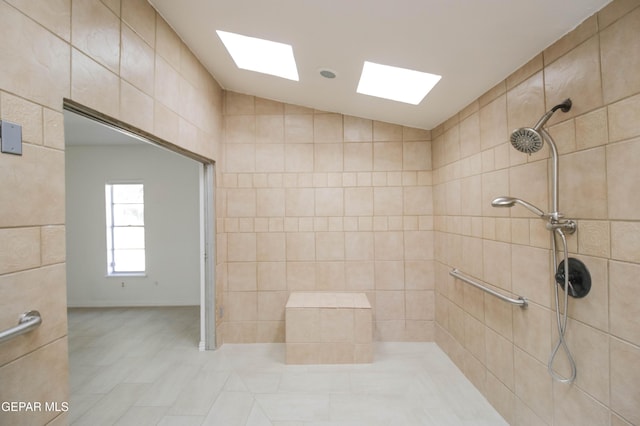 bathroom with tiled shower and vaulted ceiling