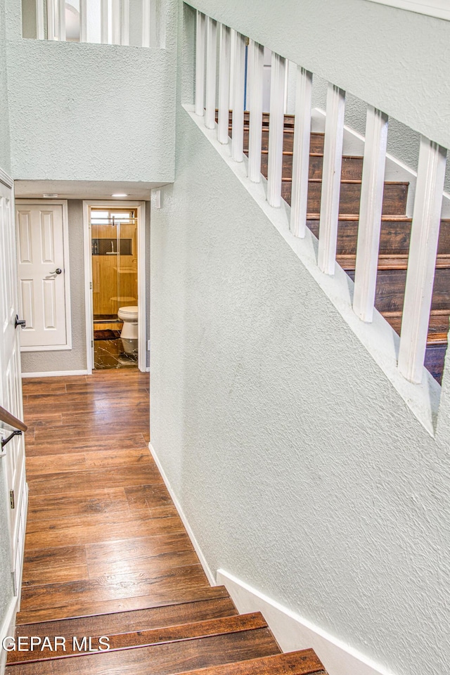 stairs with wood-type flooring