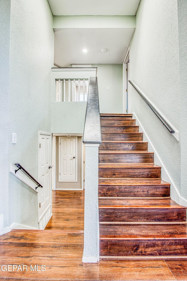 stairs featuring hardwood / wood-style flooring