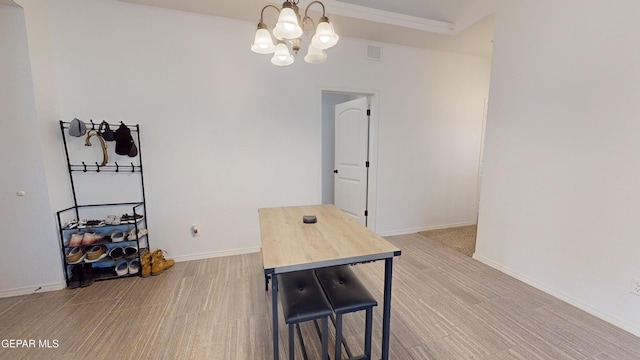 dining area with a chandelier and light wood-type flooring