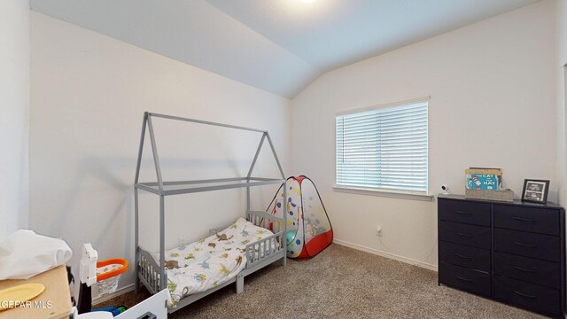 bedroom featuring lofted ceiling and carpet flooring